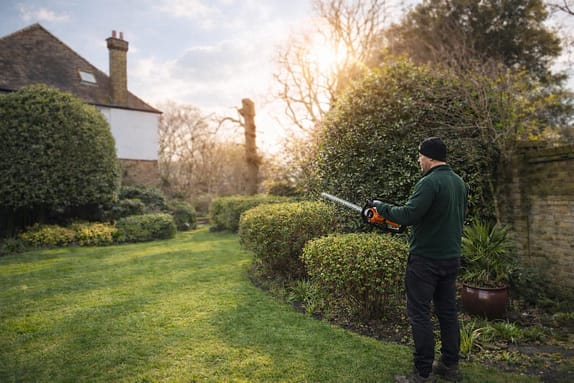 Beautiful garden with a gardening worker